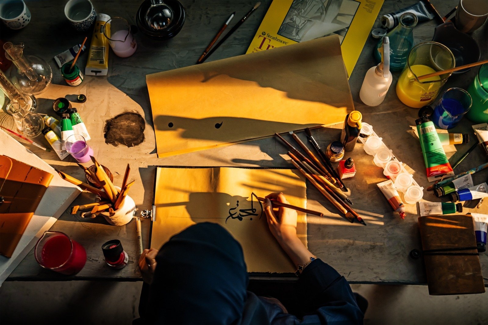 Still from the CCQ brand reveal film showing development of the Arabic calligraphic identity