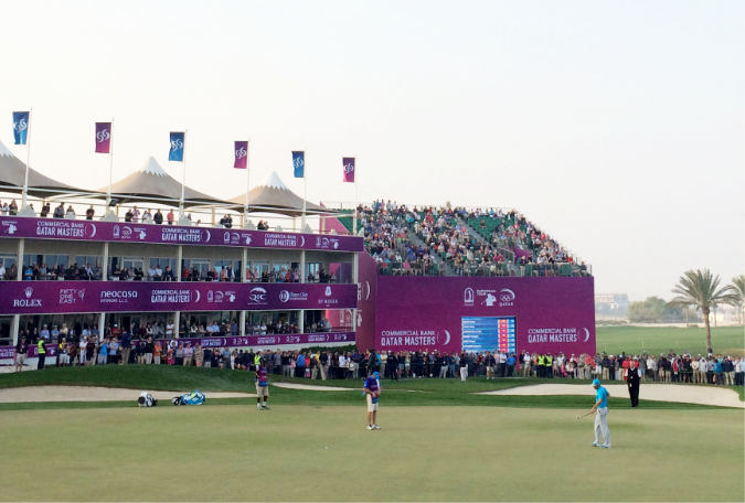 Commercial Bank Qatar Masters branding across grandstand, flags and scoreboards at the closing hole