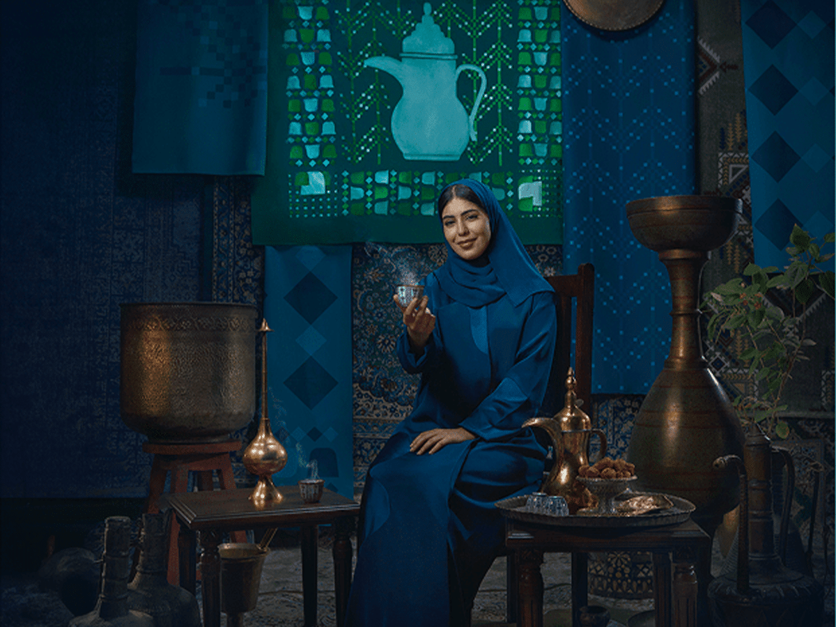 Campaign visual for Generosity, teal blue coffee dallah and finjan motif